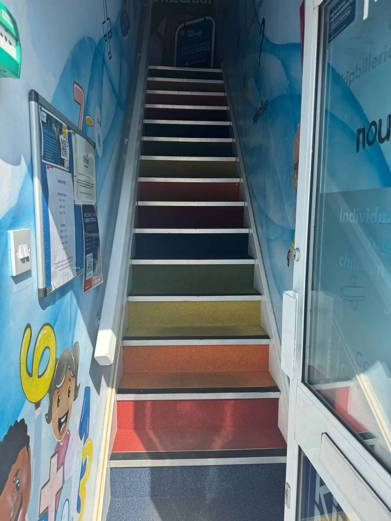 Rainbow stairs leading up to Kip McGrath Billericay on the first floor