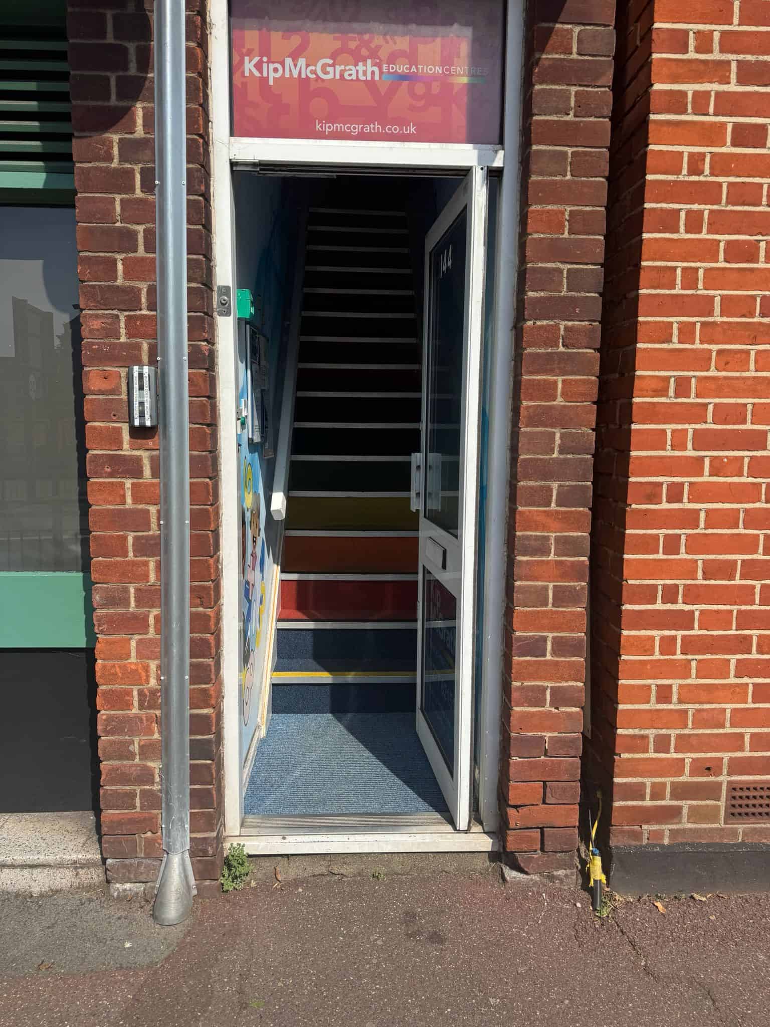 Entrance door to Kip McGrath Billericay next to the barber shop