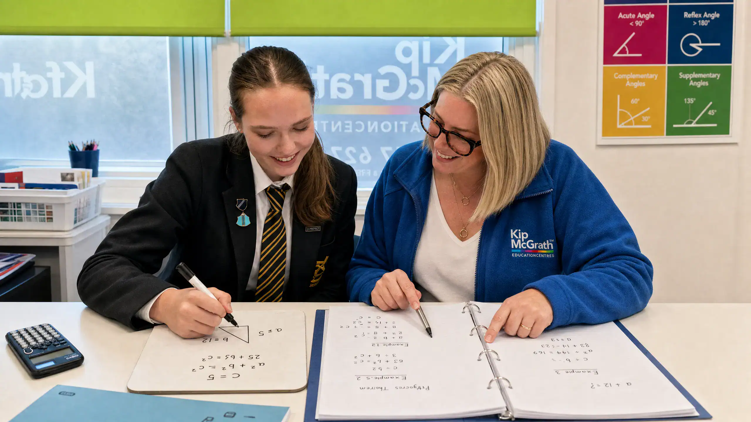 A Kip McGrath tutor helping a student with their work