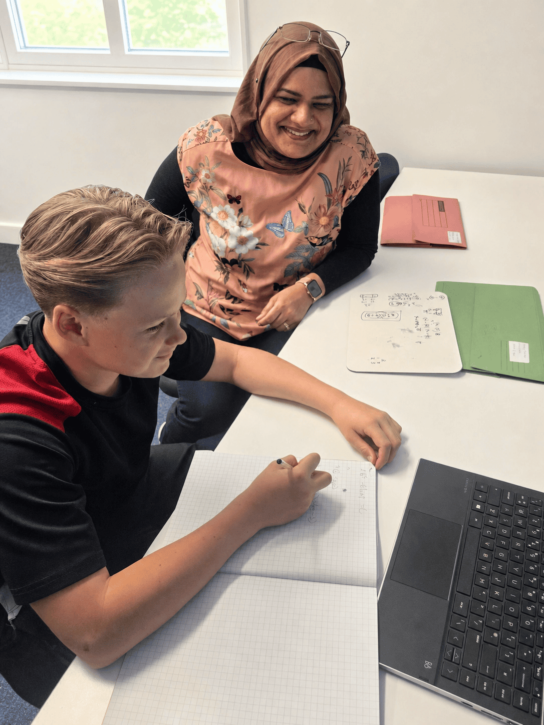 tutoring commitment to parents Billericay - tutor working with a student